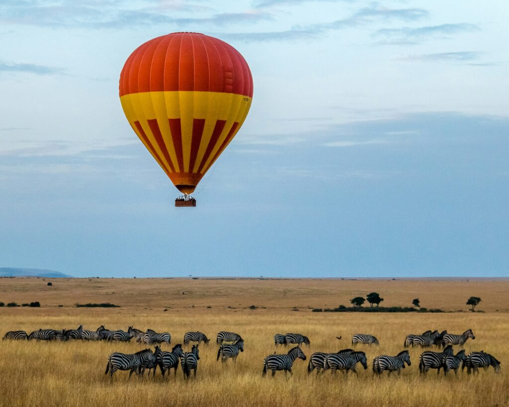 A hot air balloon drifting above the Maasai Mara plains